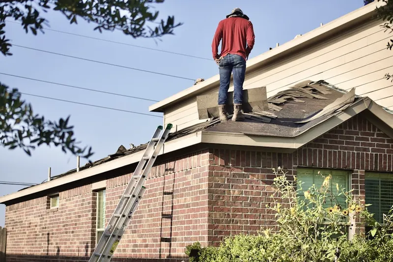 Professional roofer working on a residential roof in North Branch